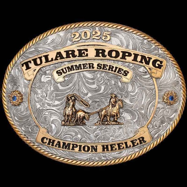 "Wear your Roping victory proudly with our Tulare Belt Buckle! This Buckle is crafted on a German Silver base. The Jewler's Bronze banners will display your lettering boldly. This Buckle is detailed with a traditional rope edge and 2 beautiful flower